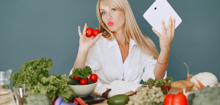 Vlogger promoting healthy eating with fresh vegetables on the table.